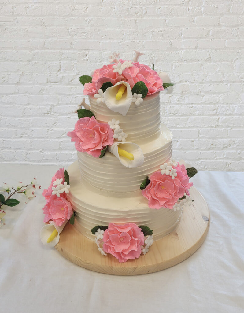 Three-Tiered Wedding Cake with pink flowers